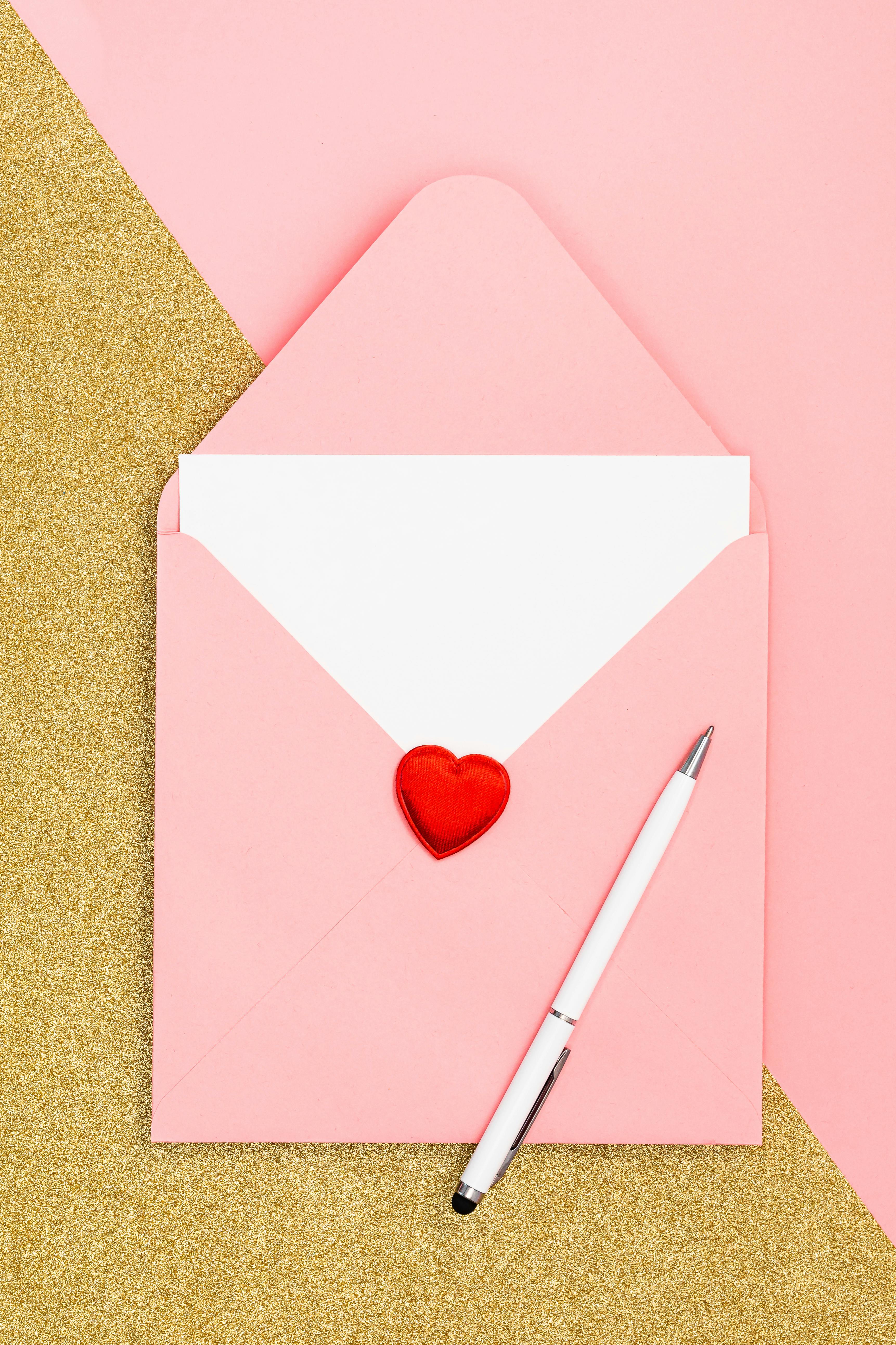 connect image of an envelope and letter, with a heart seal. A white pen is on top of the envelope and the image has a theme filter of ode to stories branding colours pink and maroon.